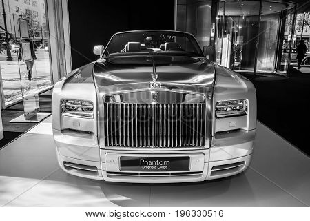 BERLIN - MARCH 08 2015: Showroom. Luxury car Rolls-Royce Phantom Drophead Coupe. Black and white. Rolls-Royce Motor Cars Limited global manufacturer of luxury cars.