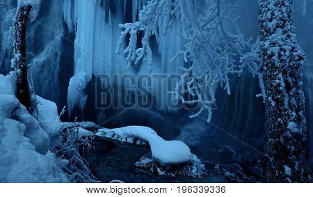 Frozen waterfall. Beautiful abstract ice scene. A misty winter day. Krushuna waterfalls in Winter. Bulgaria