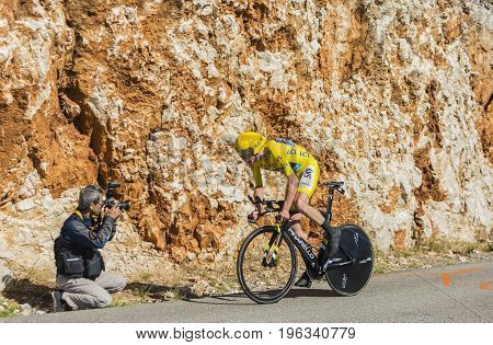 Col du Serre de TourreFrance - July 152016: Photographer taking a photo of the British cyclist Christopher Froome of Team Sky in Yellow Jersey is riding during an individual time trial stage in Ardeche Gorges on Col du Serre de Tourre during Tour de Franc