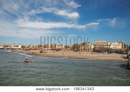 Ostia, Italy - May 18, 2013. Overview of the beach and town of Ostia between the Mediterranean sea and sunny sky The town is a seaside resort and ancient port of Rome. Lazio region