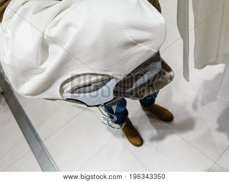 Shopping time concept. Part body buyer customer client wathing touching clothes in botique shop market.