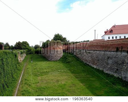 The main defensive wall of the Dubensk castle. View from the bridge. Summer day . For the background.