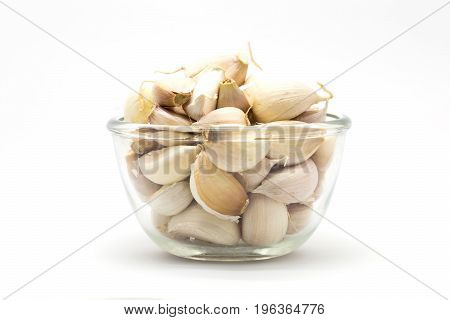 Glass cup of fresh rood gralic on white background