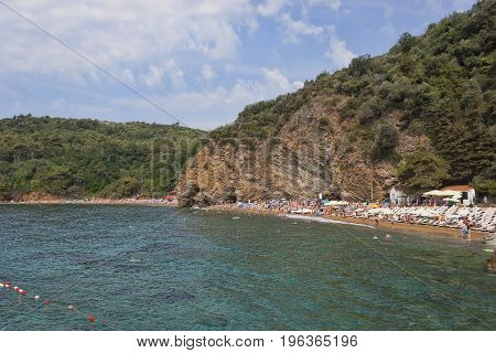 BUDVA MONTENEGRO - JUNE 26 2017: The sand and pebble beach of Mogren in Budva one of the most popular beaches on the Budva Riviera