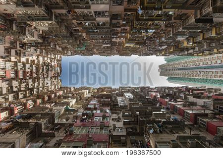 Bottom view against blue sky Apartment crowded residence area Hong Kong city