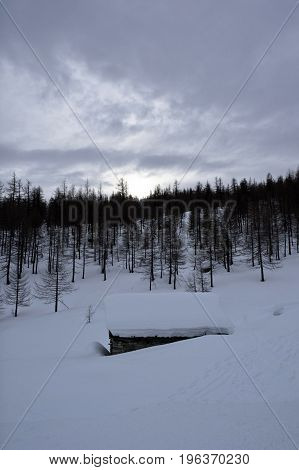 old chalet in the snow during winter