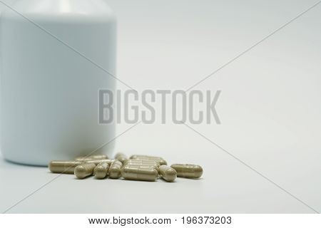 Capsule pills with bottle on white background