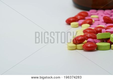 Colorful of vitamin tablets on white background