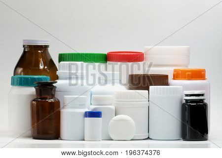 Various size and shape of bottles with cap on white background