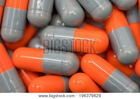 Top view of orange grey capsule pills