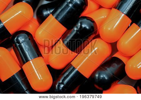 Top view of orange black capsule pills