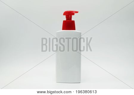 Cosmetic bottle with red pump isolated on white background
