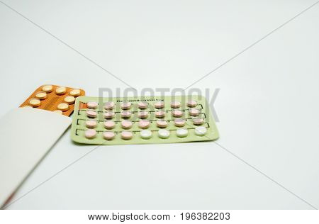 Two blister pack of birth control pills on white background