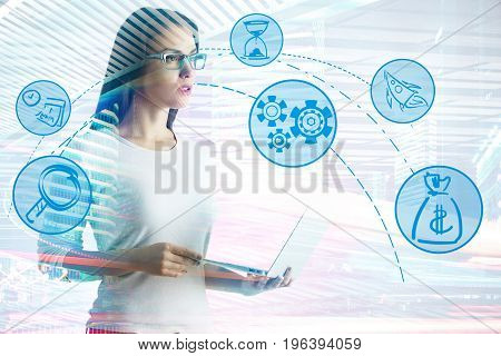 Thoughtful young woman with laptop and abstract business icons projected on light city background. Technology and communication concept. Double exposure
