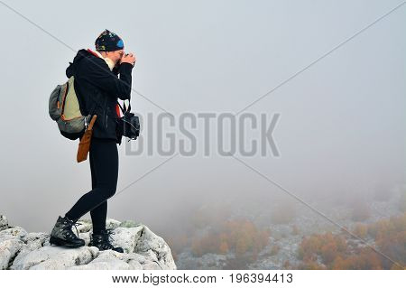 Cernei Mountains Romania - October 23 2015: Womn photographer during a hike in Cernei Mountains Romania. Shot taken on October 23rd 2015