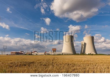 Nuclear power plant Temelin in the Czech Republic. Dusk landscape with big chimneys. Clouds of steam derailing from a nuclear power station tower.