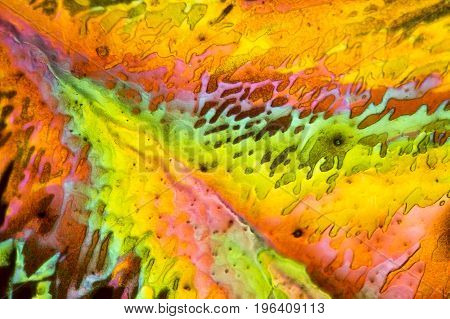 colorful microscopic shot of salt acid microcrystals in polarized light