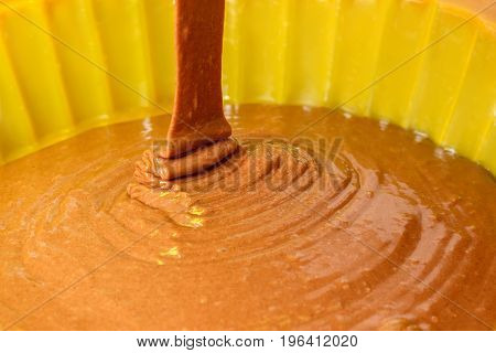 A Stream Of Chocolate Dough Filled Into A Baking Dish