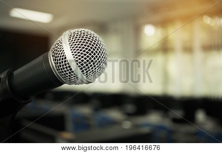 Microphone on abstract blurred of speech in seminar room or speaking conference hall light computer bokeh background