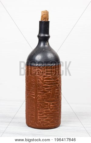 Black bottle of wine and wneglass on the background of the canvas