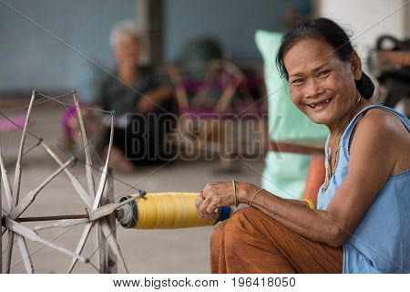 villagers of Ban Sanuan Nok Buriram Province. Thailand - April 30 2017: old women weaving traditional thai fabric at Burirum Thailand. The local silk cloth is characterised by elaborate patterns and design