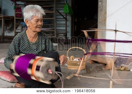 villagers of Ban Sanuan Nok Buriram Province. Thailand - April 30 2017: old women weaving traditional thai fabric at Burirum Thailand. The local silk cloth is characterised by elaborate patterns and design