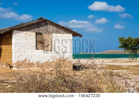 Traditional Adobe House Next To The Sea Under Blue Sky