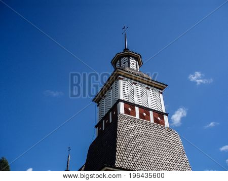 Old wooden church in Scandinavian style on a summer day