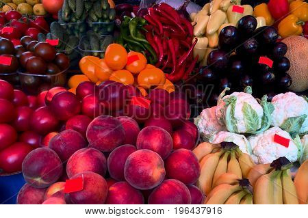 Fresh ripe vegetables and fruits on the counter in the market. Close-up.
