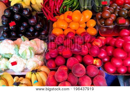 Fresh ripe vegetables and fruits on the counter in the market. Close-up.
