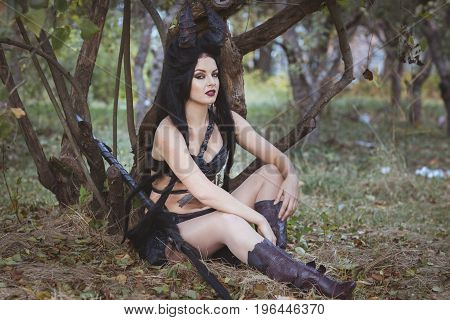 Woman from the tribe sits under a tree