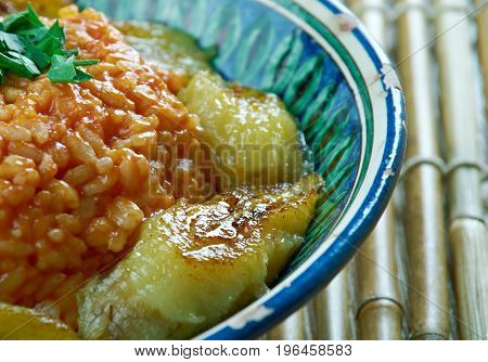 jollof rice with fried plantainsNigerian cuisine. close up meal
