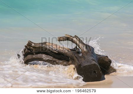 Wave breaking on the beautiful white beach of Baru island
