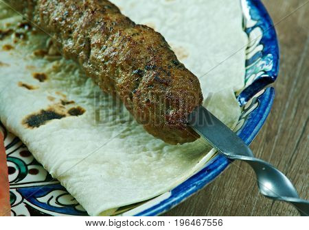 caucasian Luleh kebab with vegetable.  meat  barbeque