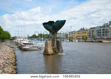TURKU, FINLAND - JUNE 13, 2015: A cloudy June day on the city embankment. View of the fountain 