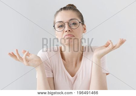 Photo Of European Teenage Girl In Big Round Spectacles Pictured Isolated On Gray Background Pulling