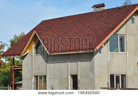 Attic construction mansard roof roof repair with asphalt shingles and plastering wall. Roofing construction.