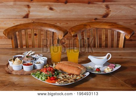 Breakfast for two in a rustic style on a wooden table.