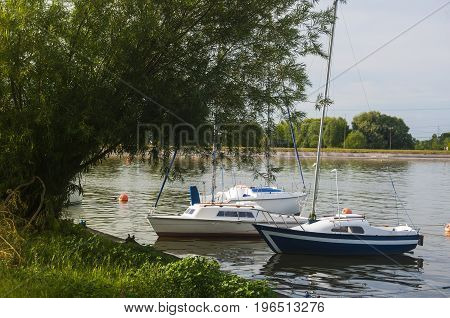 sailboats floating on lake over the coast