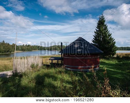 Scandinavian Sauna in front of a lake in idyllic scenery