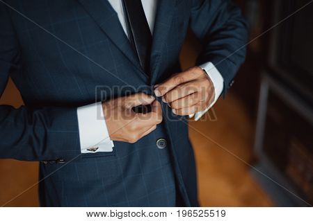 Elegant Groom In Wedding Jacket Wearing White Shirt And Turquoise Tie. Groom's Hands On Blue Suit.