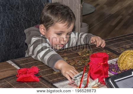 Child and a pile of money coins. Concept Save money.