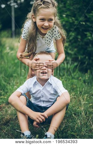 kids playing in the park, guess who, closing each other eye, siter and brother