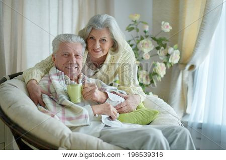 Portrait of happy senior couple resting together