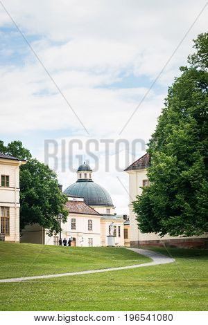 STOCKHOLM SWEDEN - JULY 5 2017: View over Drottningholm Palace and park on a sunny summer day. Home residence of Swedish royal family. Famous landmark and tourist destination in Stockholm Sweden