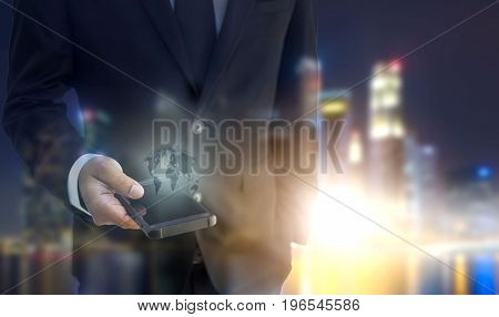 Double exposure of businessman hand hold smart phone mobile cityscape and sunset as business communication and technology concept. Elements of this image furnished by NASA.