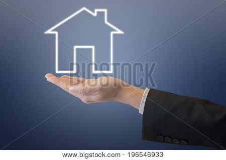 Professional Business Man Holding Out Under Digital House Icon With Clear Blue Tone Background For H