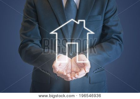 Business Man Holding Out Hands Under Digital House Icon With Clear Background For Home Purchasing, R