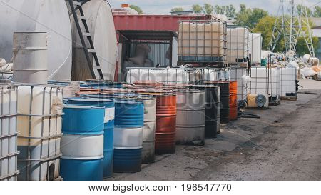 In the closed territory of the plant there are barrels with used engine oil and oil products