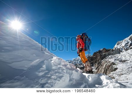 Trekker looks at the sun while crossing Cho La pass in Everest region Nepal